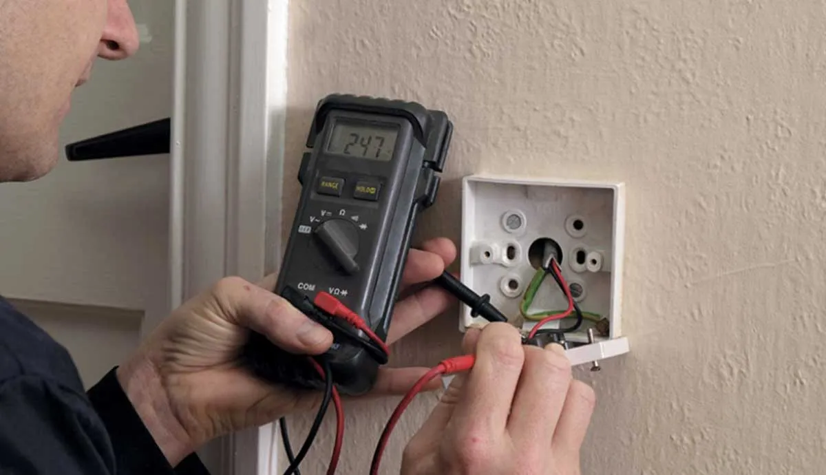 male working on interior electrical box